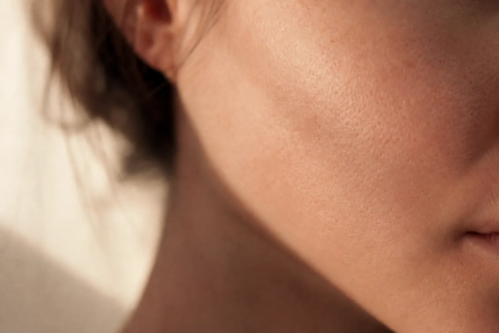 A close view of skin in soft daylight, showing natural texture.